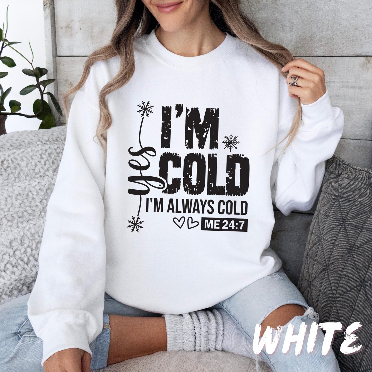 White unisex sweatshirt with bold black lettering that reads "Wake Me Up When Winter Is Over," decorated with snowflakes, dots, and botanical elements. A cozy, funny cold-weather pullover for adults and kids.