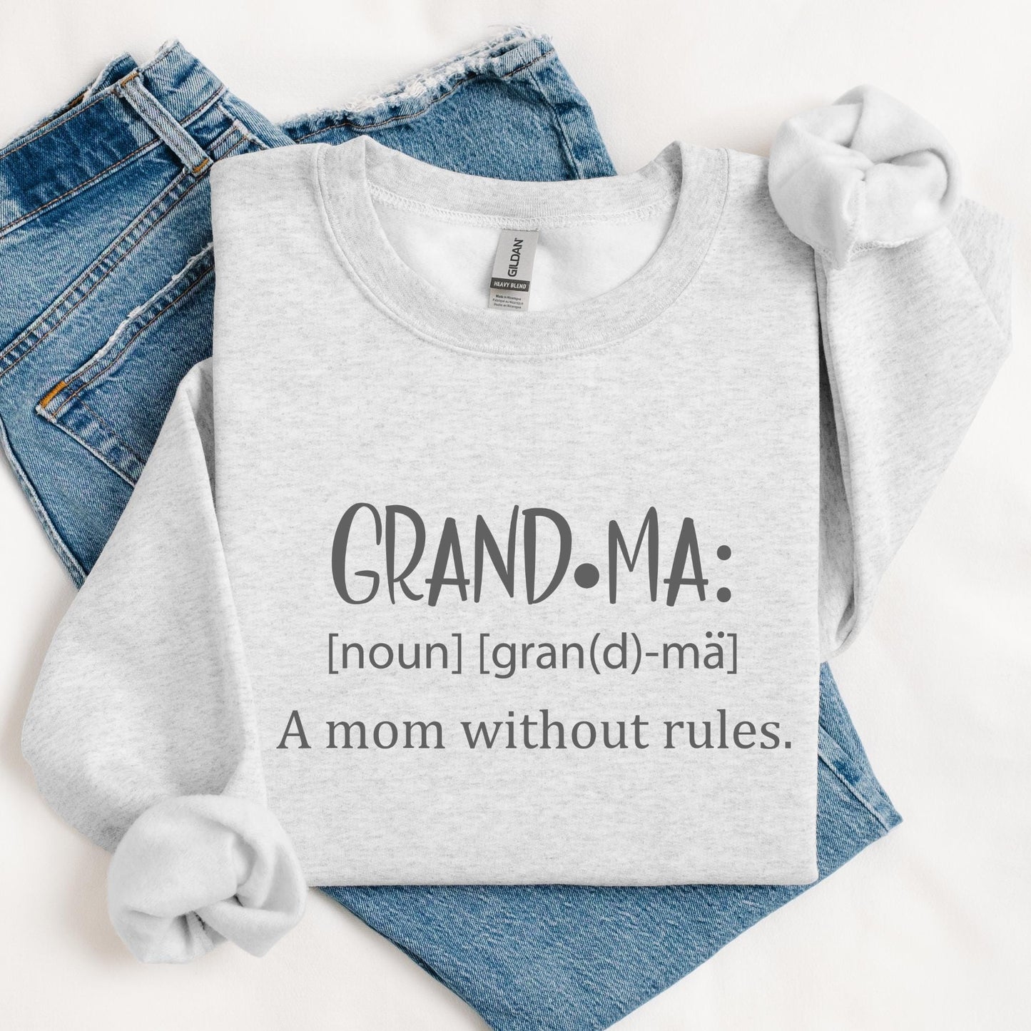 Cozy sweatshirt with 'GRANDMA: [noun] [gran(d)-mä] A mom without rules.' in playful typography, perfect gift for Mothers Day