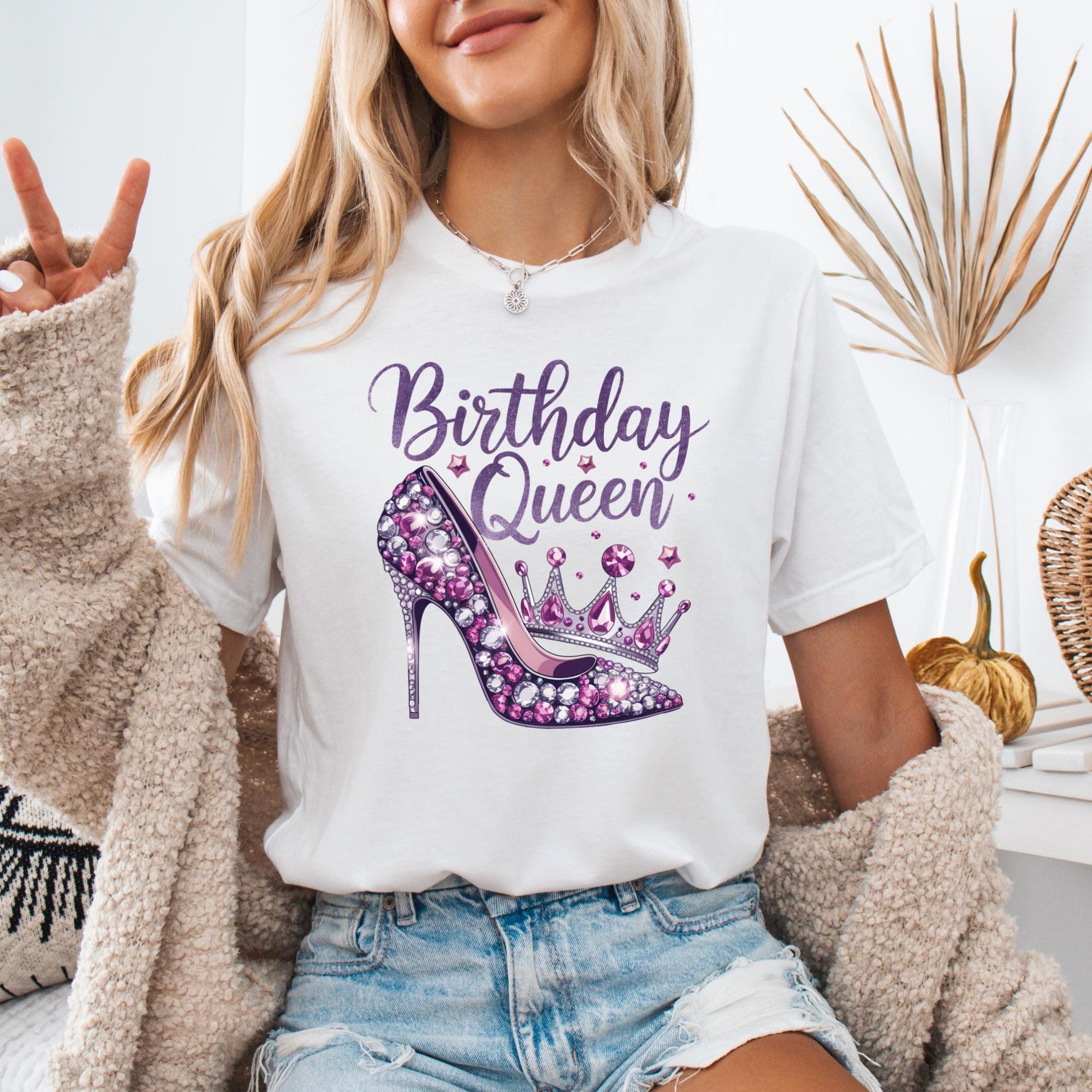 Birthday Queen shirt design featuring a glamorous purple high heel with gemstone details, a matching jeweled crown, and elegant script font with sparkles.