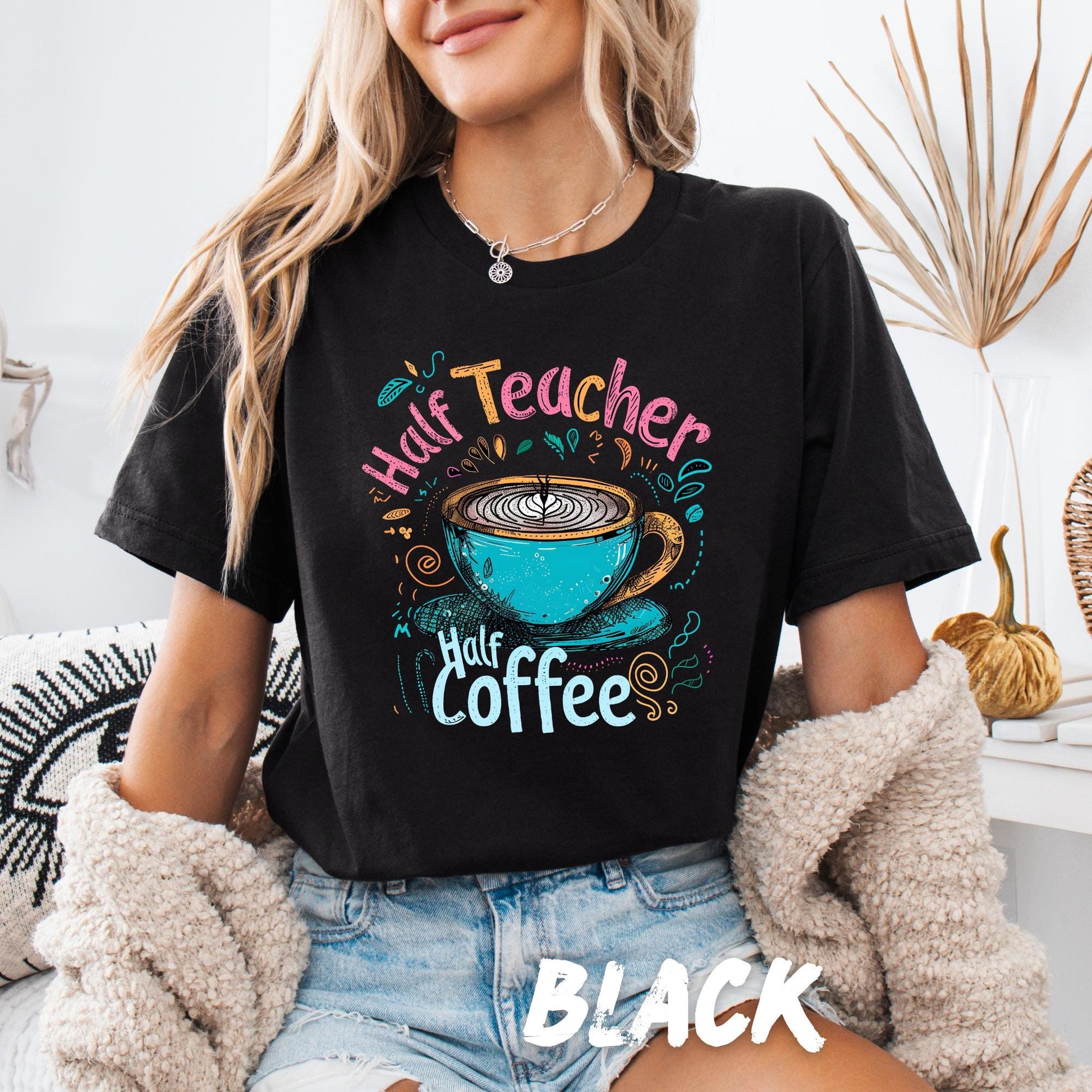 colorful graphic design with the phrase "Half Teacher Half Coffee." The design includes a vibrant, hand-drawn style illustration of a blue coffee cup with latte art, surrounded by decorative swirls and doodles in shades of pink, yellow, and teal.