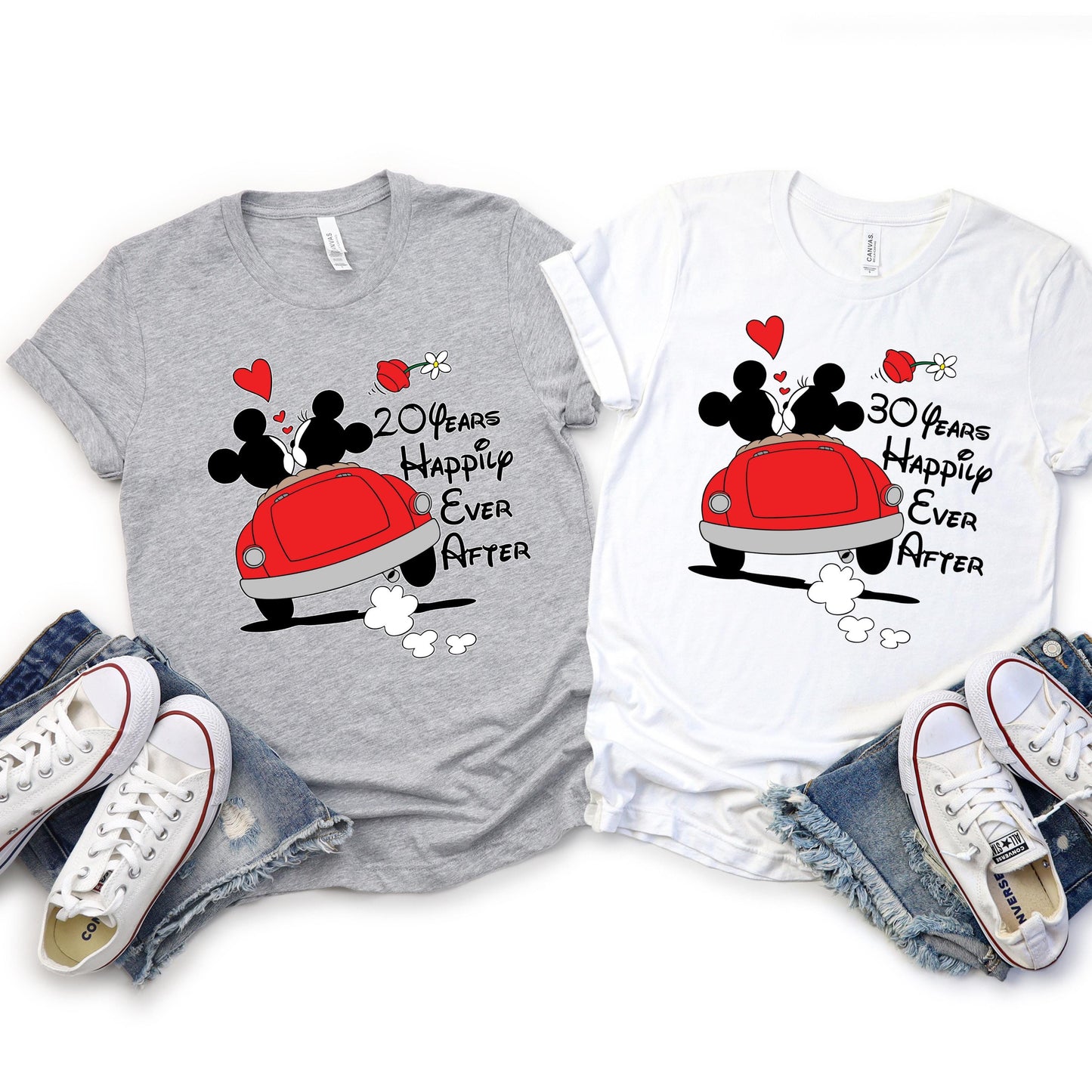 custom anniversary T-shirts laid flat, each with a cartoon design of Mickey and Minnie Mouse kissing in a red car with hearts and flowers above. The gray shirt reads '10 Years Happily Ever After,' and the white shirt reads '8 Years Happily Ever After.' The number of years is customizable.