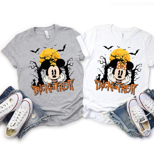 Halloween “Trick or Treat” Disney character shirts featuring spooky full moon and bats background, with six design options: Mickey Mouse, Minnie Mouse, Donald Duck, Daisy Duck, Goofy, and Pluto. Perfect for matching Halloween outfits for Disney trips, family gatherings, and festive events.