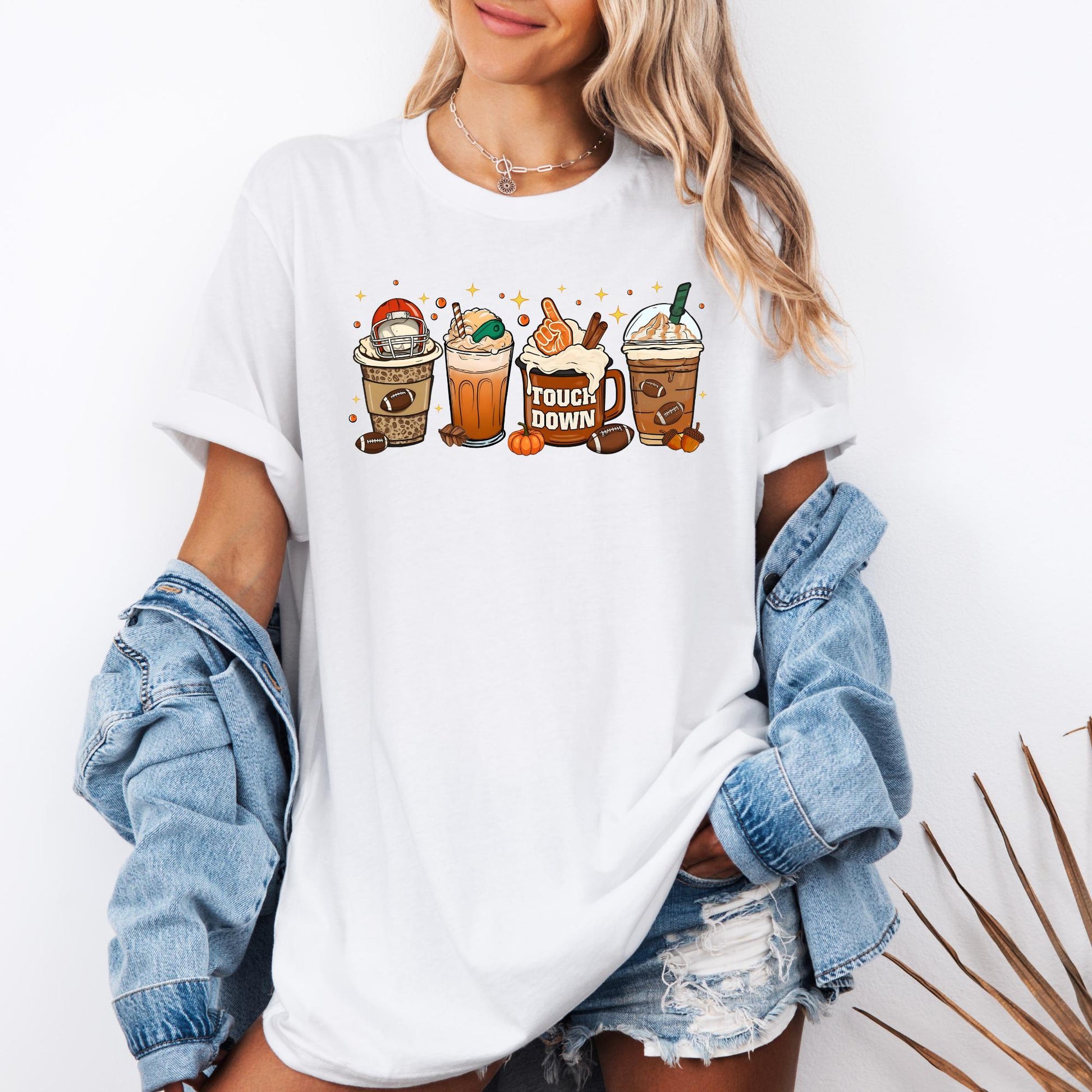 unisex SHIRT with fun fall coffee drinks featuring football-themed toppings, whipped cream, and "TOUCHDOWN" mug design. A cozy pullover for coffee lovers and game day fans—available in multiple colors for adults and kids.