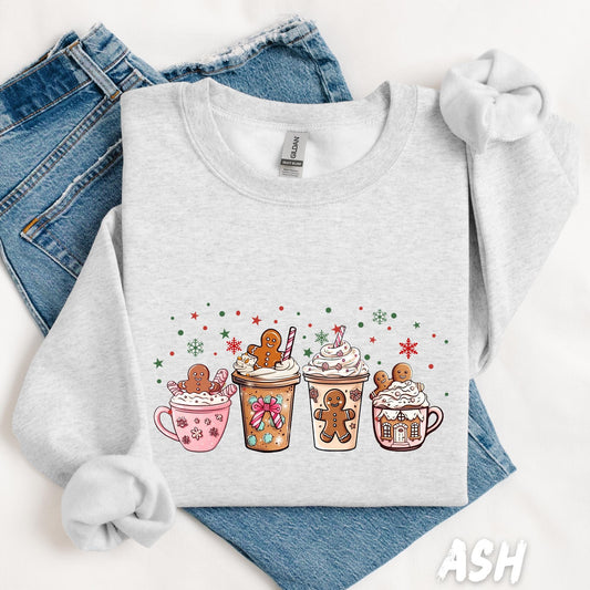 unisex sweatshirt with a cute holiday design featuring five mugs and to-go cups of cocoa topped with whipped cream, candy canes, and gingerbread men. Decorated with festive sprinkles, snowflakes, and stars. A cozy Christmas design for winter drink lovers.