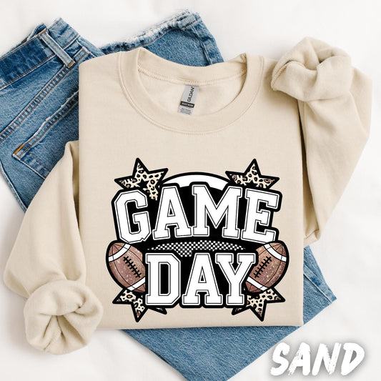 unisex sweatshirt with bold white text that reads &#39;GAME DAY&#39; in varsity-style font, decorated with football graphics and leopard print stars around the lettering