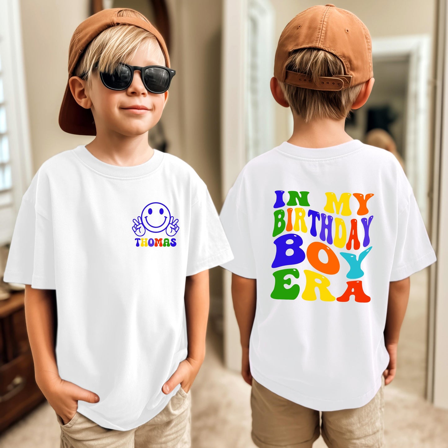 Custom kids birthday shirt design featuring a smiley face with peace signs and personalized name on the front, and colorful retro text “In My Birthday Boy Era” on the back. Fun, personalized birthday t-shirt for boys.
