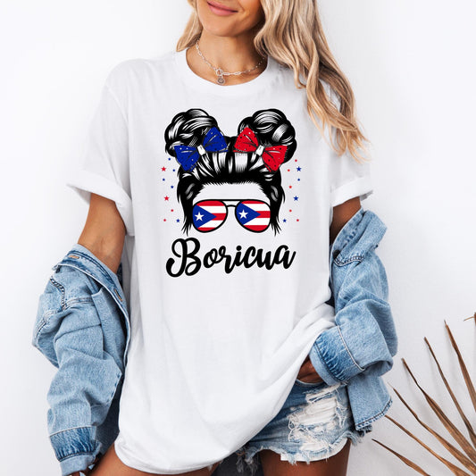 Puerto Rican pride t-shirt featuring a “Boricua” design with a woman’s hair in a bun, red and blue bows, and sunglasses showing the Puerto Rico flag. This Puerto Rico shirt listing includes multiple design options: “Boricua girl with sunglasses,” “Puerto Rico text with flag,” “Puerto Rico tropical style,” “Chancla Survivor,” “I’m Not Yelling I’m Puerto Rican,” “Puerto Rico heart flag,” “Puerto Rican cultural collage,” and “Yo Soy Boricua” with map and flag.