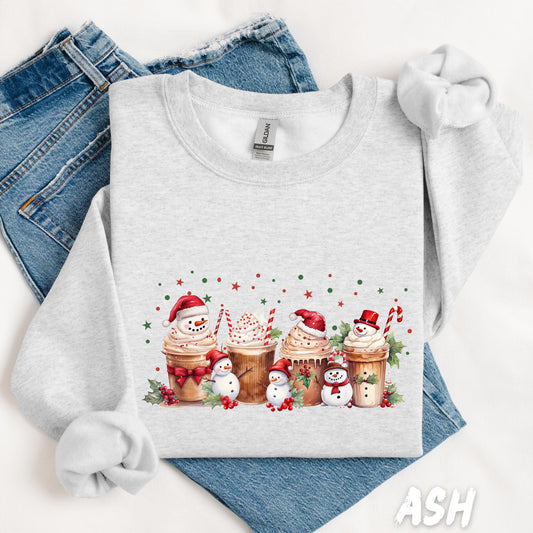 Unisex Christmas sweatshirt in light ash gray featuring a festive cocoa and snowman design. Cozy winter graphic with whipped cream mugs, candy canes, and holly accents — perfect for the holidays. Soft cotton-poly blend ideal for cold-weather comfort.
