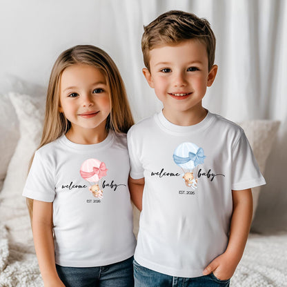 Matching family shirts with ‘Welcome Baby’ design featuring a teddy bear in a pink hot air balloon, perfect for celebrating a newborn arrival or baby shower. Available in all sizes for mom, dad, and baby.