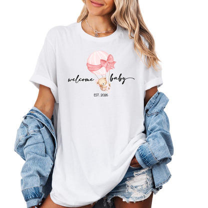 Personalized family T-shirts with ‘Welcome Baby EST. 2026’ design, featuring a soft watercolor teddy bear and balloon — perfect for welcoming a new baby.