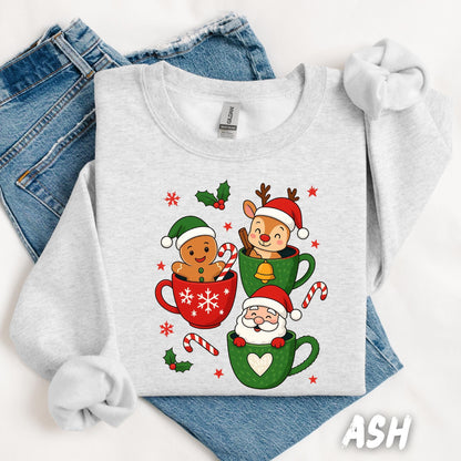 Cute Christmas sweatshirt with gingerbread man, reindeer, and Santa inside festive holiday mugs, kawaii Christmas graphic tee, cozy winter sweater for holiday season.