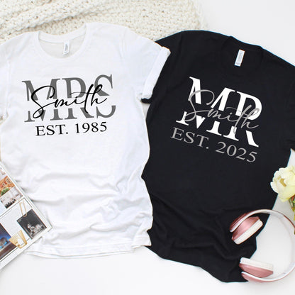 Matching unisex custom anniversary t-shirts with personalized surname and EST year, available in black and white, perfect for couples and wedding anniversaries.