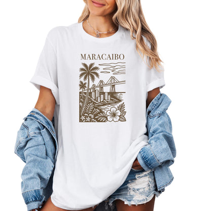 graphic t-shirt featuring a Maracaibo, Venezuela city illustration with palm trees, bridge, skyline, and tropical floral design.