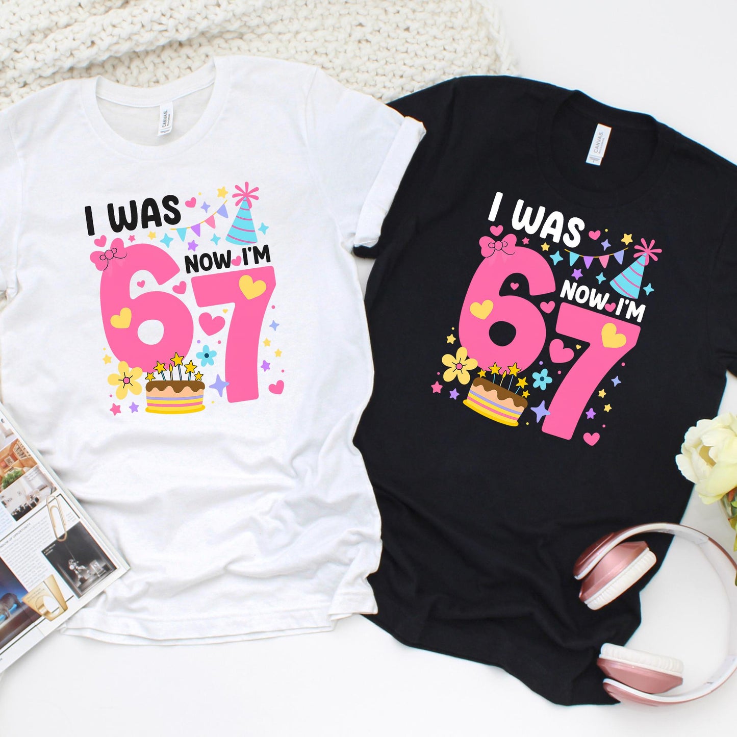birthday graphic t-shirts laid flat, one white and one black, featuring a colorful “I Was 6 Now I’m 7” design with pink numbers, hearts, stars, party hat, and cake illustration, perfect for a 7th birthday celebration.