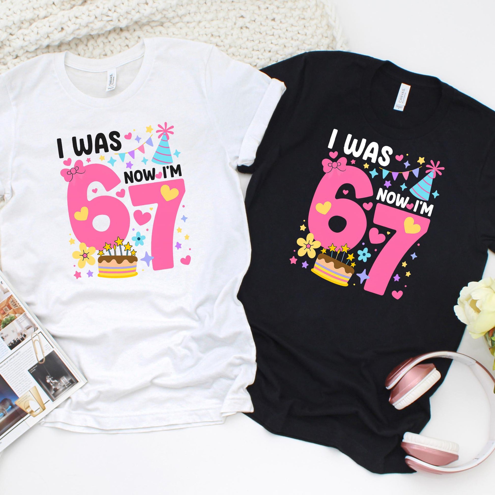 birthday graphic t-shirts laid flat, one white and one black, featuring a colorful “I Was 6 Now I’m 7” design with pink numbers, hearts, stars, party hat, and cake illustration, perfect for a 7th birthday celebration.