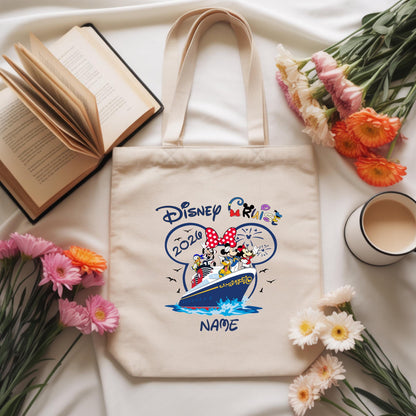 cotton tote bag featuring a Disney Cruise Line design with Mickey Mouse, Minnie Mouse, Goofy, Donald Duck, and Pluto on a cruise ship. The name 'Sophia' is printed in blue below the artwork. The bag is customizable with any name or text, available in different Disney-themed images to choose from