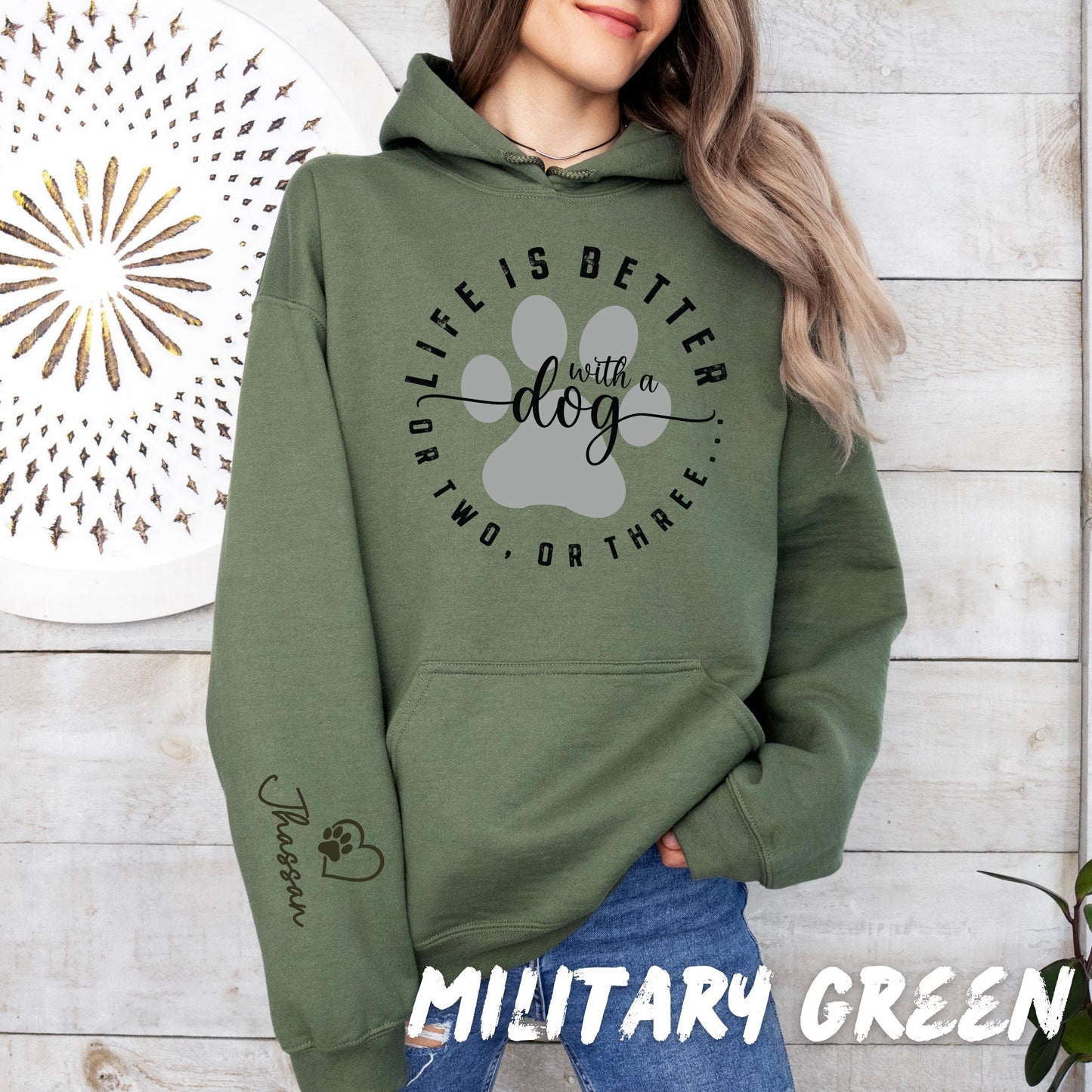 Custom dog lover hoodie with minimalist paw design and pet name printed on sleeve