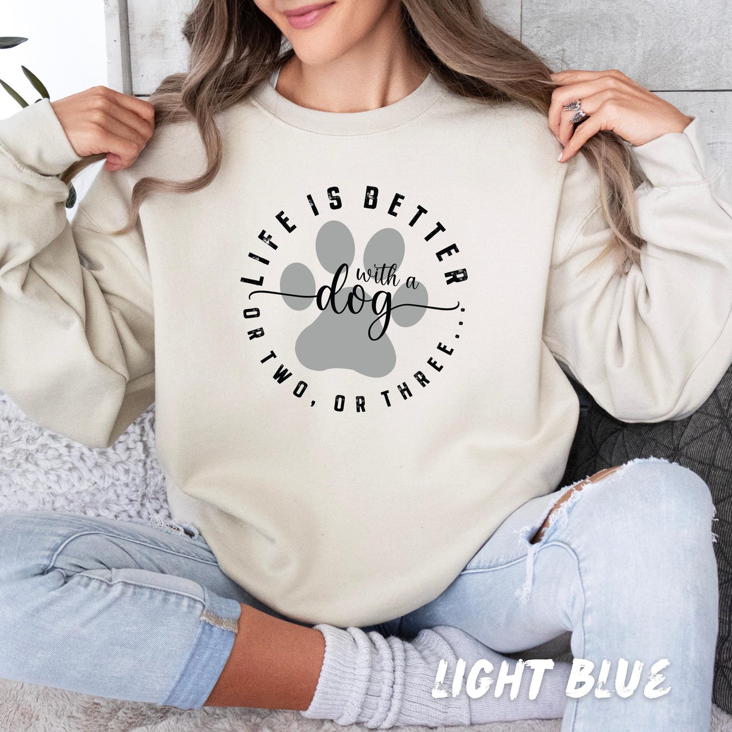 Custom dog owner gift hoodie with paw design and personalized dog name on sleeve