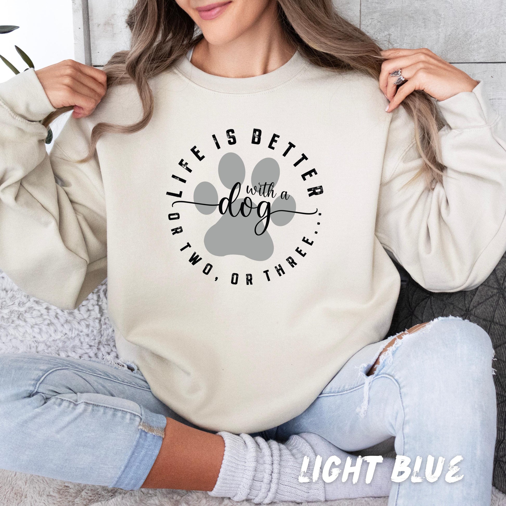 Custom dog owner gift hoodie with paw design and personalized dog name on sleeve