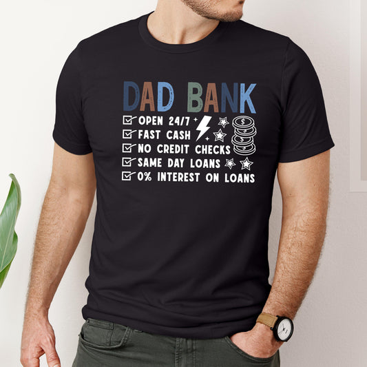 Funny Dad Bank t-shirt with humorous sayings about fast cash, same day loans, and 0% interest printed on a black unisex shirt.