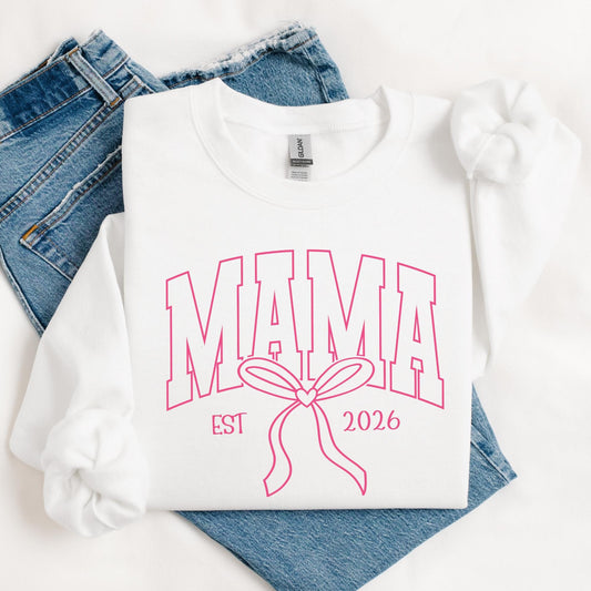 White Gildan crewneck sweatshirt featuring a pink varsity-style "Mama" design with a coquette bow, perfect for Mother's Day and everyday mom style. Custom EST.