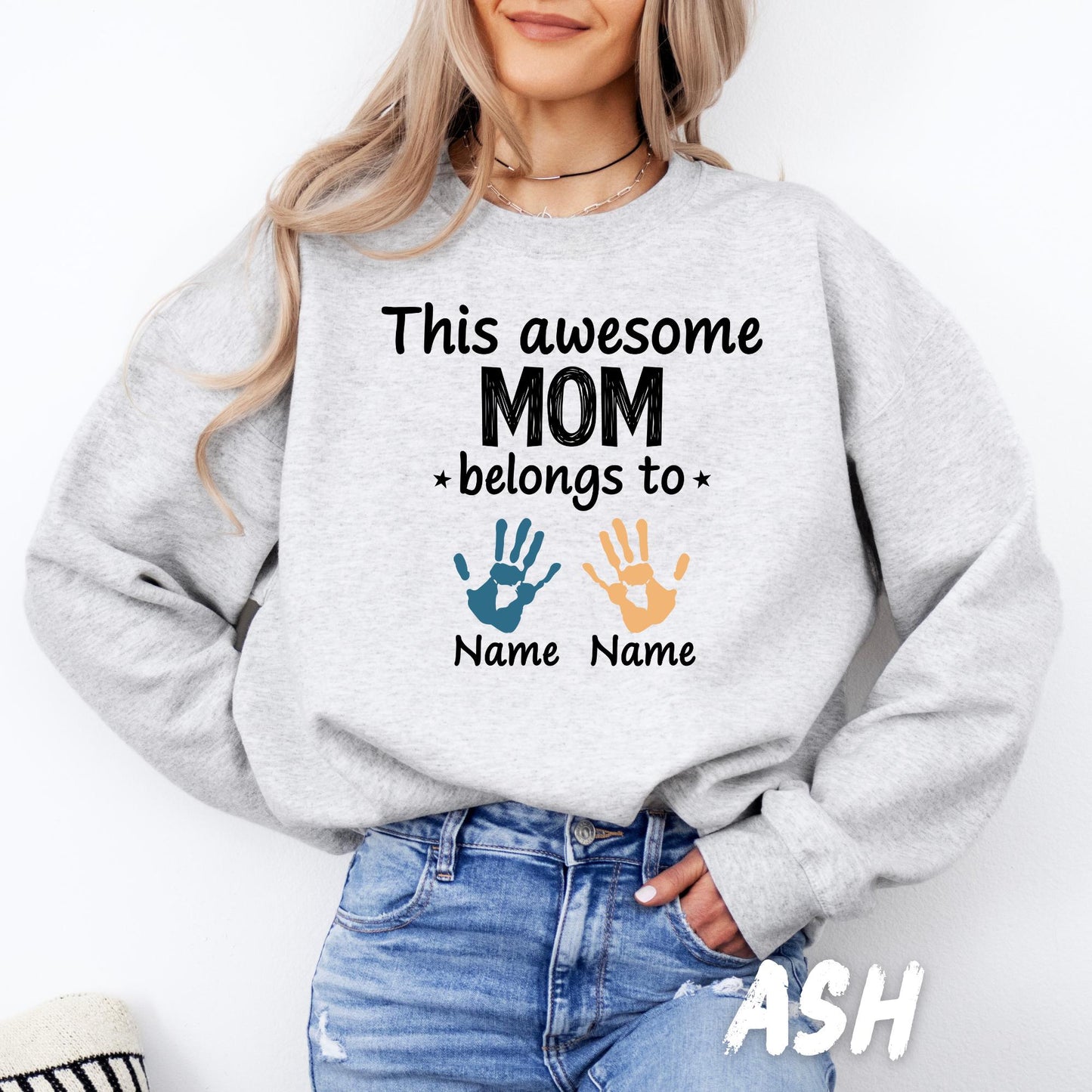 Gildan crewneck sweatshirt featuring a personalized "This Awesome Mom Belongs To" design with custom children's names and colorful handprints, perfect for Mother's Day.