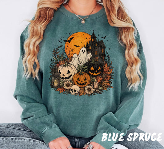 Comfort Colors unisex crewneck sweatshirt featuring a vintage cottagecore Halloween design with friendly ghosts, haunted house, pumpkins, autumn florals, lantern, skull, candles, bats, and an orange harvest moon.