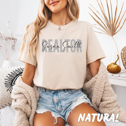 Custom Realtor shirt with personalized name printed across the chest in layered typography, unisex softstyle T-shirt available in multiple colors.