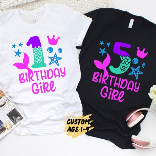 White and black softstyle birthday girl shirts featuring a colorful mermaid design with customizable ages from 1 to 9 for girls' birthday celebrations.
