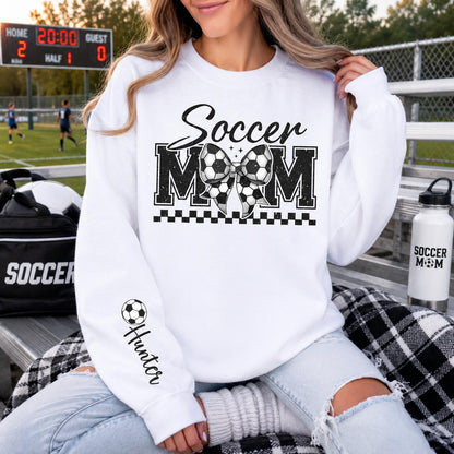 White Gildan crewneck sweatshirt featuring a personalized Soccer Mom design with customizable player name, perfect for game days and soccer season.