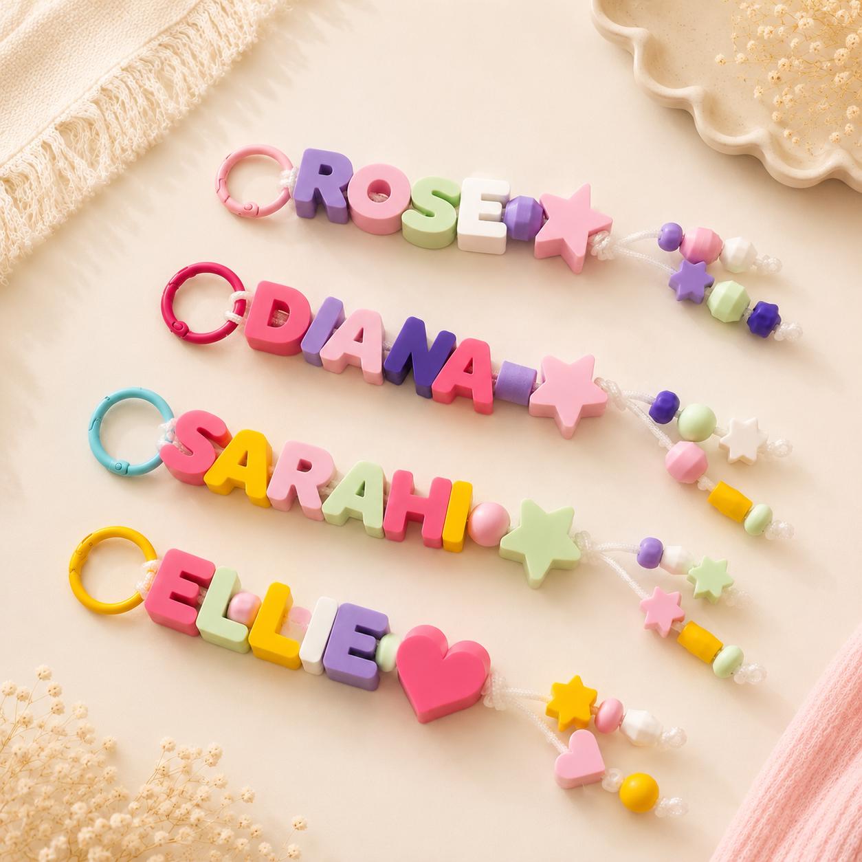 Collection of colorful personalized bag charms displayed on a neutral background, perfect for backpacks, purses, and keys.