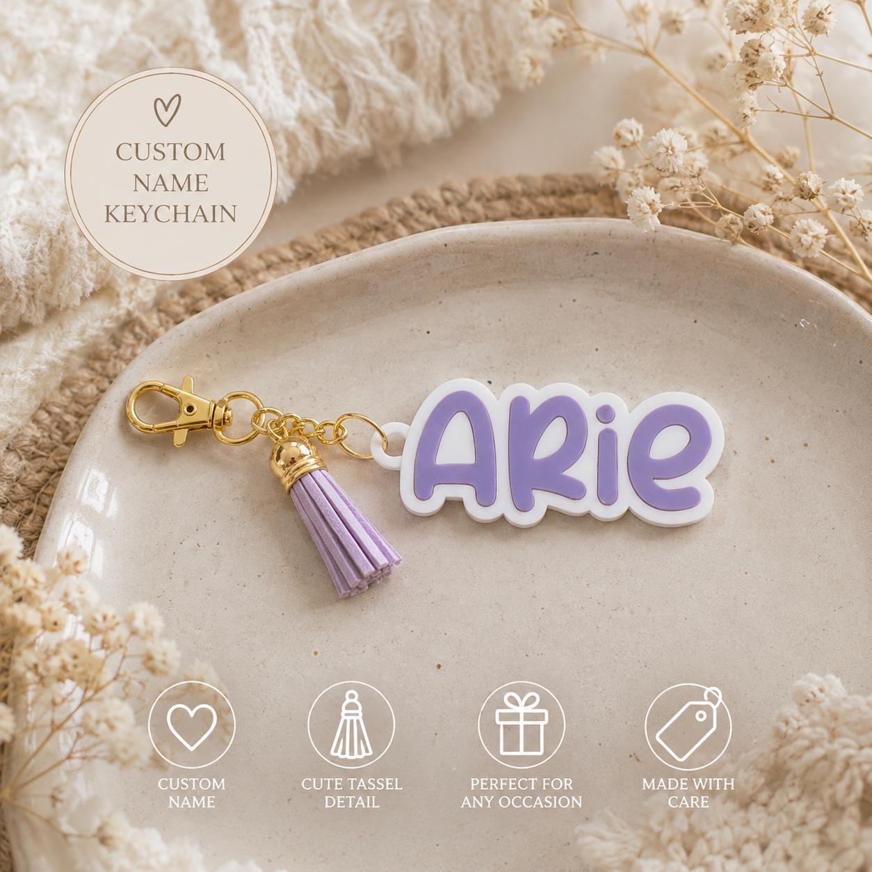 Personalized name keychain with lavender letters, white base, gold clasp and coordinating purple tassel.