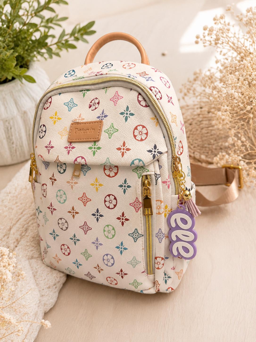 Personalized name keychain attached to a small backpack showing the size and use as a custom backpack charm.