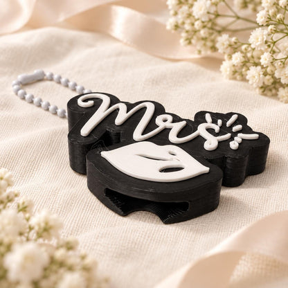 Side view of the Mrs can opener showing its thickness, raised white lettering, lips design, and slot for lifting can tabs.