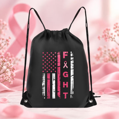 Black drawstring backpack featuring a distressed American flag design in pink and white with breast cancer awareness ribbon and vertical Fight lettering.